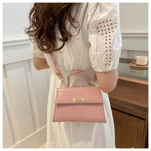 Vue arrière du sac à main rose gaufré crocodile avec fermoir doré et bandoulière