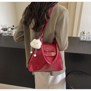 Close-up of a vintage dark red tote bag featuring a cute cloud charm and bow detail