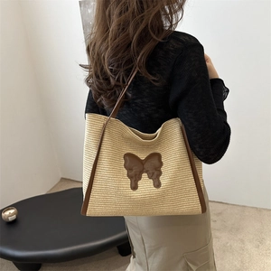 Chic woven tote bag with brown butterfly applique and slender shoulder straps