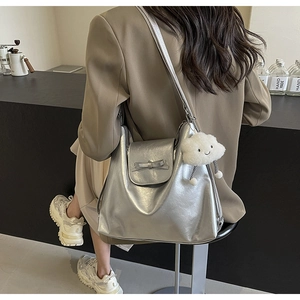 Close-up of a silver tote bag with metallic texture and cute white cloud charm