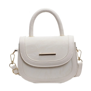 Minimalist beige saddle crossbody bag with top handle and gold metal accents for women