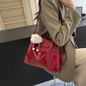 Minimalist deep red glossy leather tote bag for women featuring a white cloud plush charm