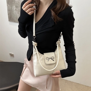 Chic cream underarm bag with silver metallic bow and versatile crossbody strap