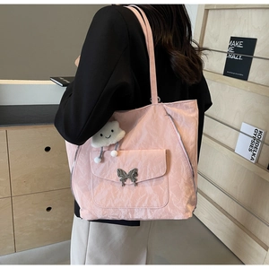 Pink pleated tote bag with silver butterfly buckle and cute cloud pendant shown on model