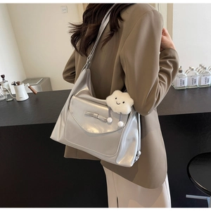 Detail of silver tote bag with bow pocket and white cloud charm for casual daily commute