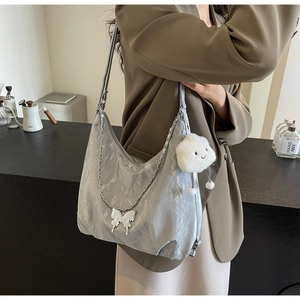 Silver metallic Hobo bag with butterfly charm and cloud pendant on metal chain strap