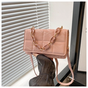 Close-up of pink marbled faux leather small square bag with quilted chain detail