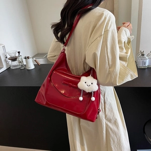 Chic red faux leather tote bag with a bow detail and cloud charm for daily commute