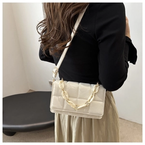 Detail of off-white quilted crossbody bag with chunky chain strap and PU leather texture