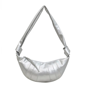 Minimalist silver croissant shoulder bag with quilted texture and knotted wide strap