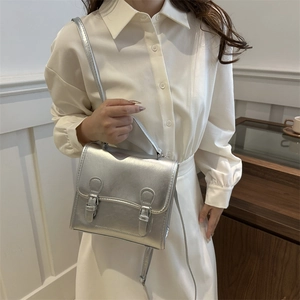 Fashionable silver metallic retro messenger bag for women with top handle and strap