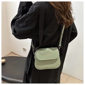 Detail of mint green matte PU leather flap crossbody bag with FASHION & BAGS text