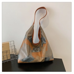 Detail of hobo tote bag featuring vintage grey and tan geometric color block design