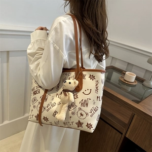 Stylish graffiti tote bag for women with bear pendant and brown leather shoulder straps
