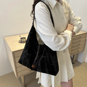 Vintage black velvet tote bag with pleated texture and amber drawstring charm detail