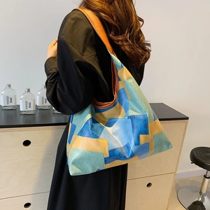 Large color-block leather tote bag for women featuring stylish patchwork design and wide straps