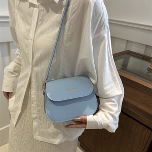 Fashionable light blue crossbody flap bag for women featuring gold-stamped lettering