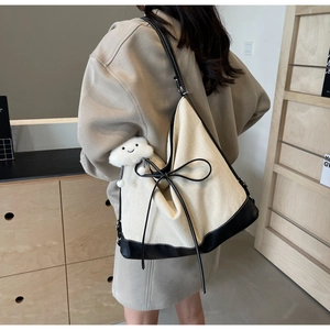 Detailed back view of a minimalist canvas tote bag with a cloud pendant and bow decor