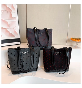 Three stylish canvas tote bags with heart and dot prints and metallic bow details