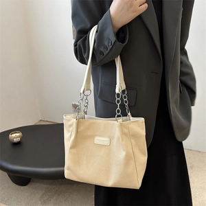 Minimalist beige corduroy tote bag with chain strap and fashion label for daily commute