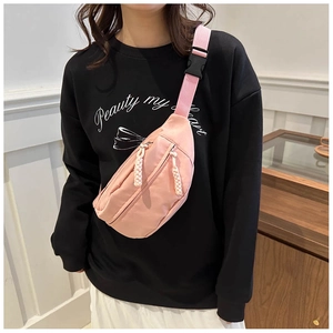 Detail of pink crossbody sports bag with double zippers and woven decorative puller strings