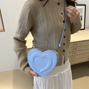Fashionable light blue heart-shaped crossbody bag with embossed dual-heart design and gold text