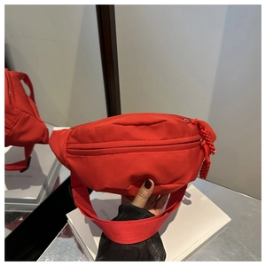 Detail view of the red waterproof nylon waist bag with unique woven rope zipper pulls