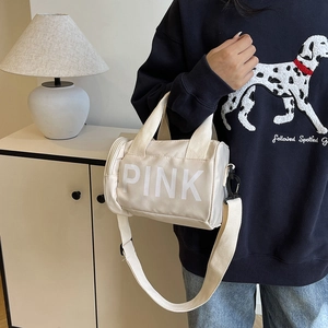 Chic cream white cylindrical crossbody bag with white PINK logo and top handle