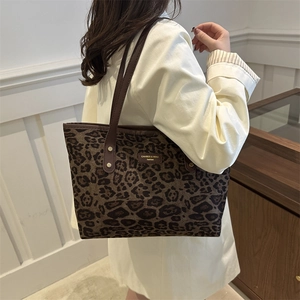 Retro leopard print tote bag with brown leather straps and vintage metallic brand logo