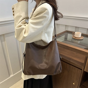Minimalist large coffee brown shoulder tote bag in stylish commute lifestyle setting