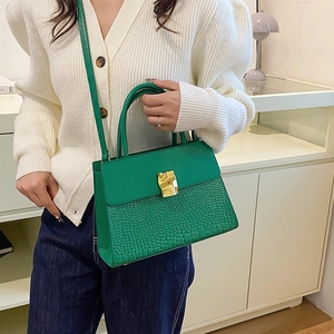 Chic green crocodile embossed leather crossbody bag with elegant gold metal buckle hardware