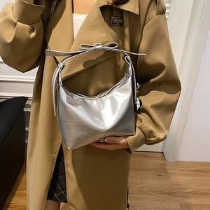 French design silver crescent hobo bag with bow handle and metallic pleated finish