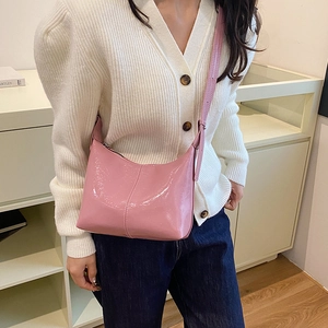 Pink patent leather crescent bag for women with glossy finish and shoulder strap