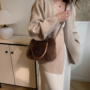 Sac bandoulière chic en fausse fourrure marron avec sangle en cuir dans un décor