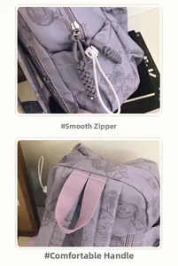 Detail of purple backpack featuring smooth dual zippers and a comfortable pink handle strap