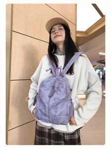 Detail view of lightweight lavender backpack with cute purple bear patterns and drawstrings