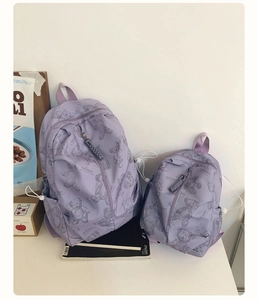Detail of two lavender teddy bear backpacks in different sizes for travel and school