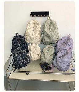 Detail view of stylish bear print backpacks in multiple colors and sizes for students