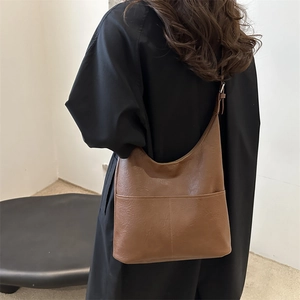 Large dark brown faux leather tote bag for commuting with a minimalist vintage design