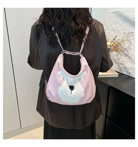 Detailed back view of a pink shoulder bag with white plush dog motif worn by a model