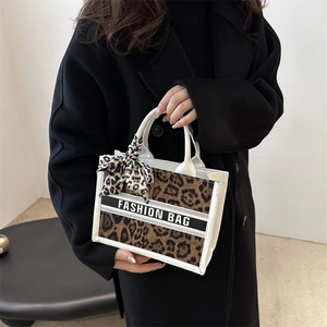 Stylish large leopard print tote bag with white leather trim and fashion strap handle
