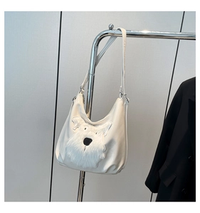 Detail of white faux leather tote bag featuring a cute 3D schnauzer dog plush design