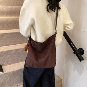 Retro coffee brown large capacity hobo tote bag for women shown in a casual street style