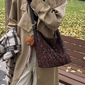 Vintage leopard print hobo tote bag with black leather strap and teddy bear charm accessory