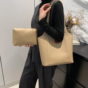 Minimalist beige contrast tote bag and small pouch set shown on model in stylish room