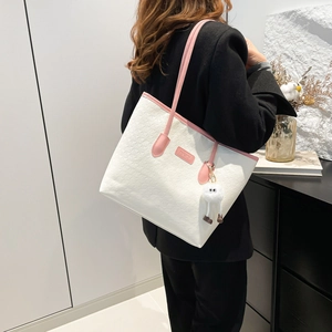 Fashionable white textured tote bag with pink handles and pompom charm for women
