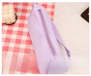 Close-up of smooth metal zipper and side handle on lavender nylon crescent bag