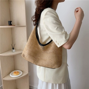 Chic woven tote bag with black leather trim and handles for casual summer style