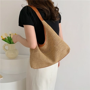 Winter casual woven tote bag with brown leather trim and hollow straw pattern