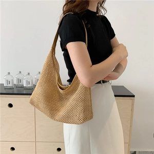 Chic woven beige tote bag with leather strap, half-moon silhouette in vintage aesthetic